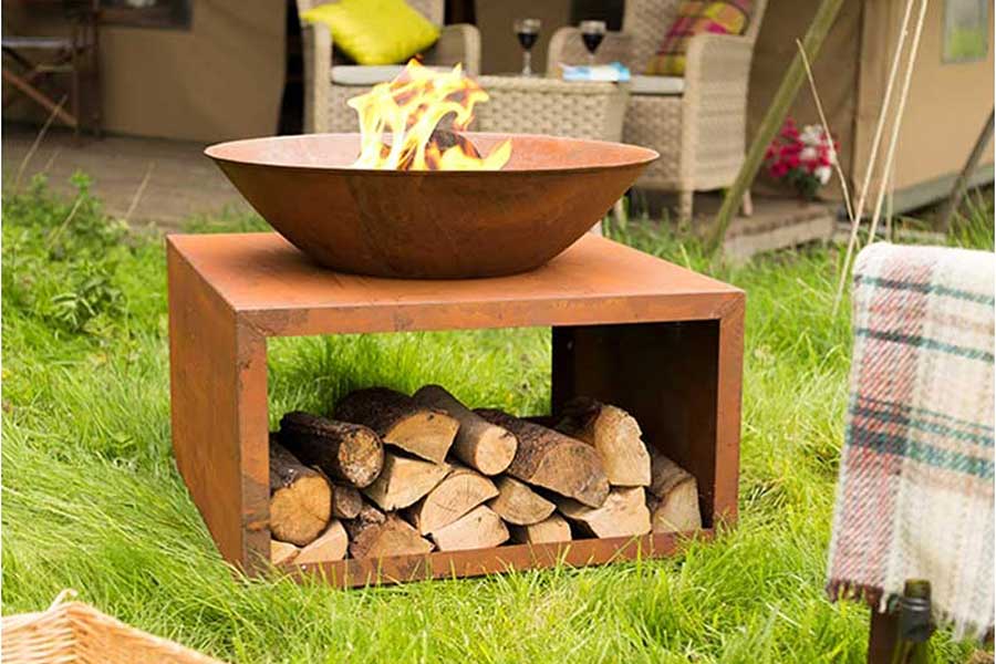 Modern Moho fire pit bowl with log storage in oxidised steel finish